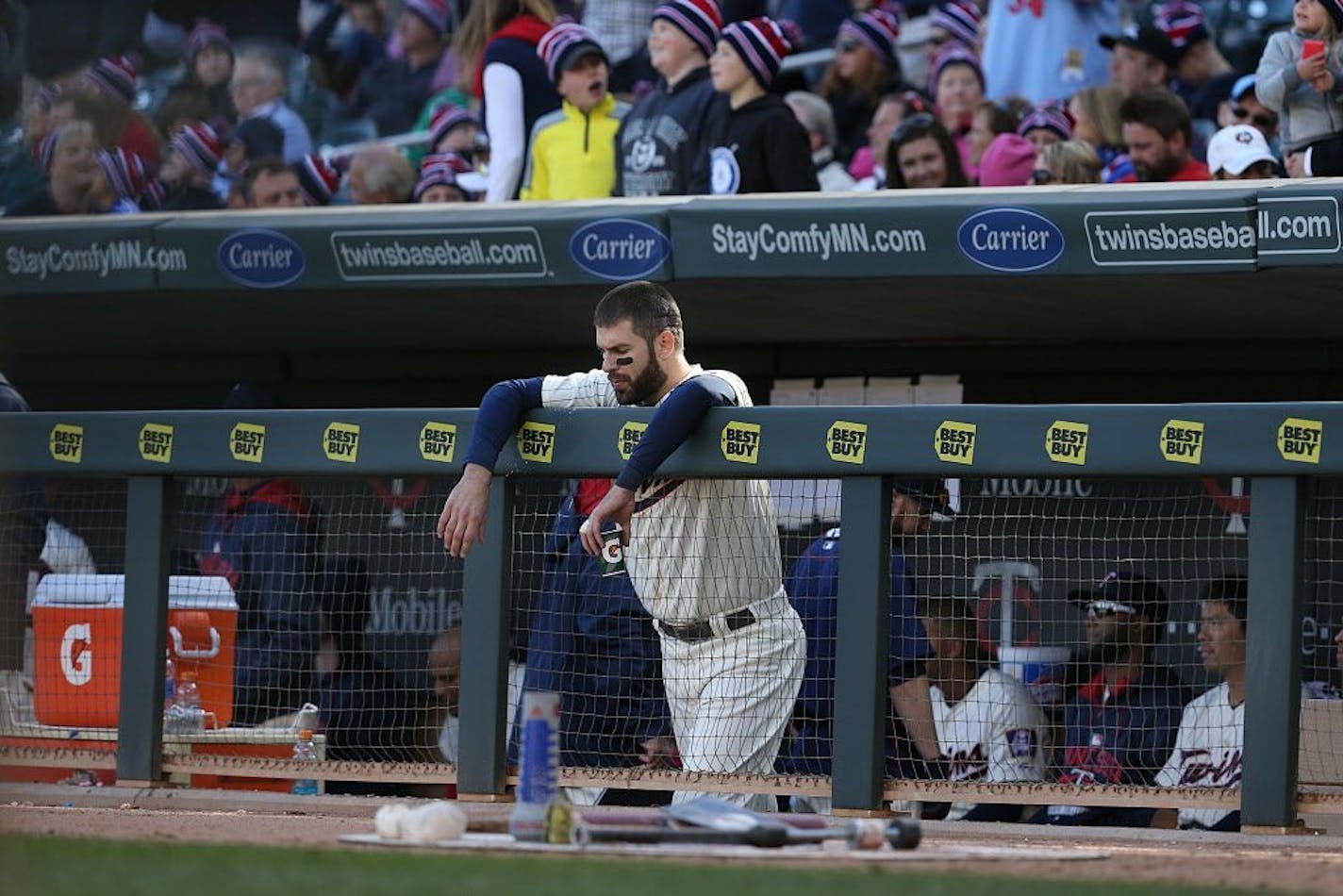 Twins Joe Mauer stood in the dugout during a game at Target Field. Next season the fans behind the dugout will be protected by a net.