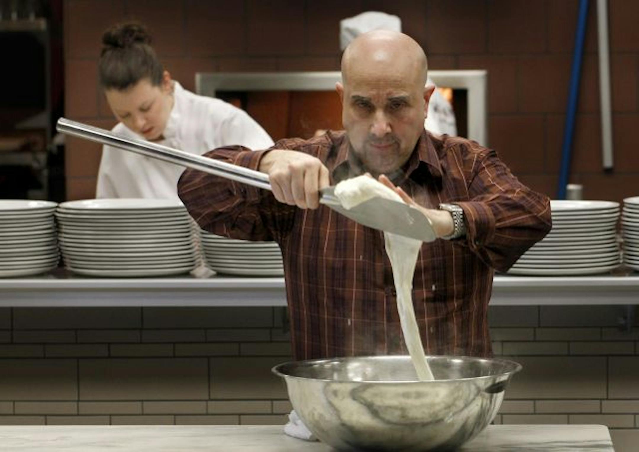 Vittorio Renda, consulting chef at Mozza Mia, stretches fresh mozzarella.