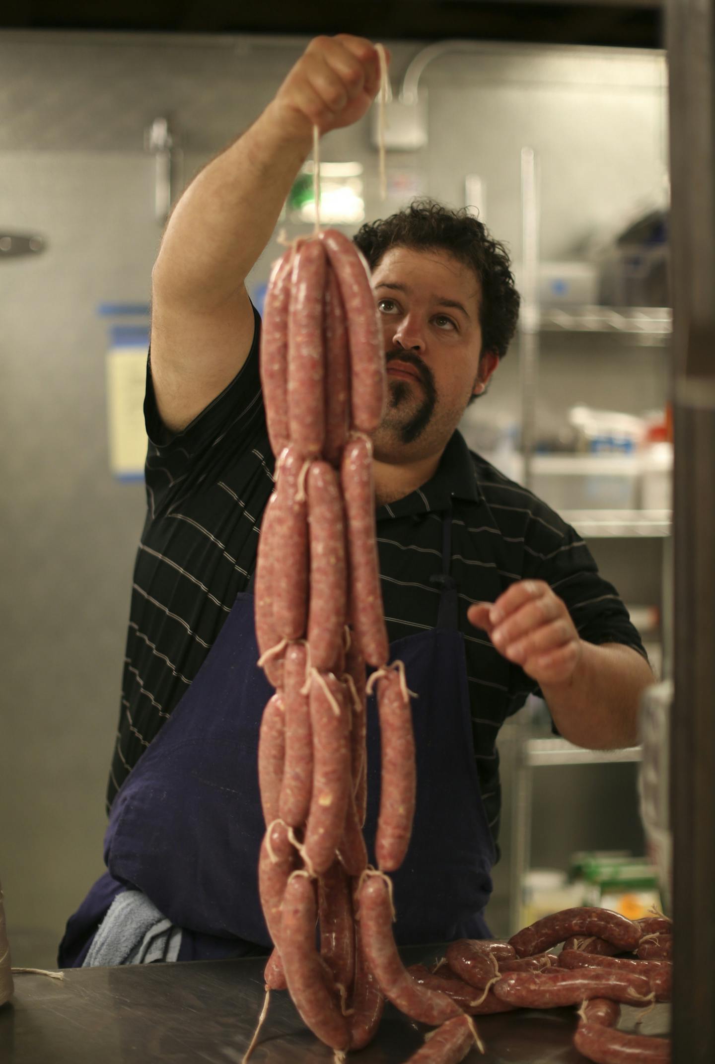 Chef Mike Brown hoisted a brace of brats he was making as a favor for a regular customer Wednesday night at Travail. ] JEFF WHEELER &#xef; jeff.wheeler@startribune.com Restaurant owners across the Twin Cities say they can't find enough cooks. The state's workforce has dropped by about 30,000 in the past three months, exposing the state's tight labor supply. At Travail in Robbinsdale, the owner/chefs can't do all the cooking themselves to they hire cooks to help them. They're currently down three