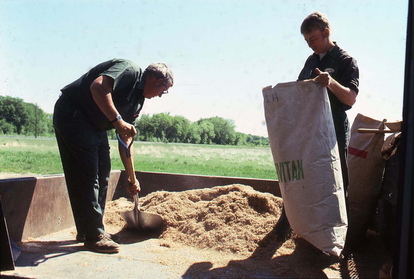 Mixing prairie seed by hand for the first planting in 1969 at Crow Hassan.