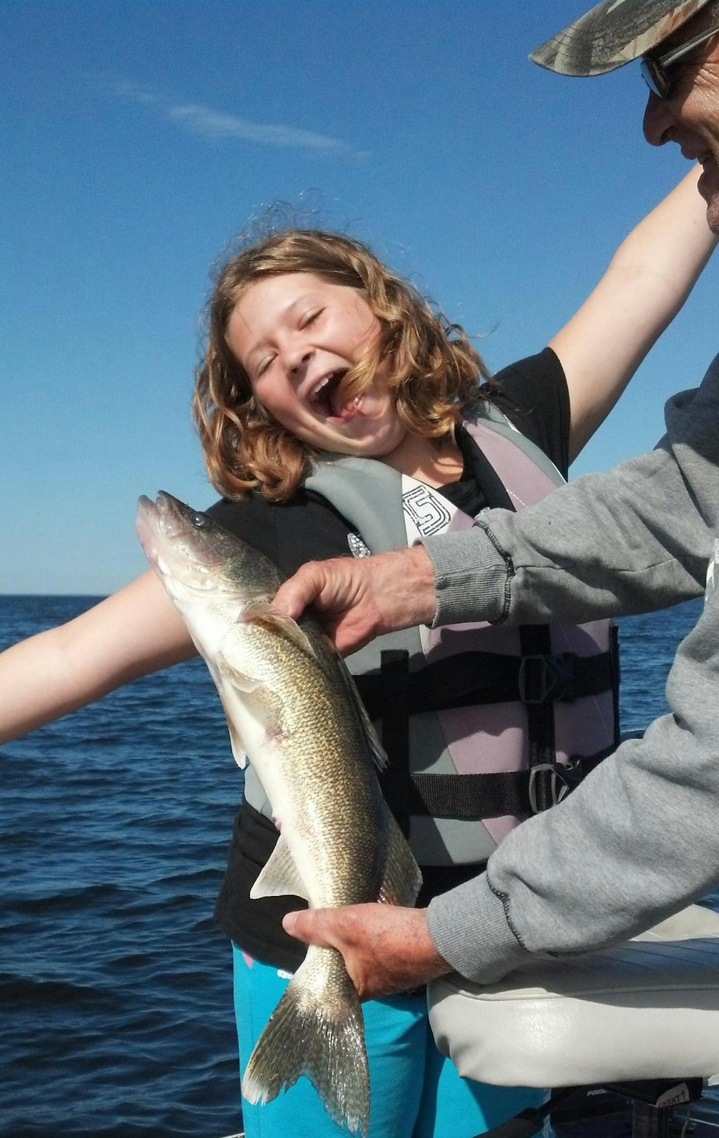 HAPPY ANGLER Neleh Hash, 10, of Lakefield, Minn., celebrated her first walleye, caught on a jig and minnow at the Northwest Angle of Lake of the Woods. Holding the fish was her grandpa, Jack Beardsley, also of Lakefield.