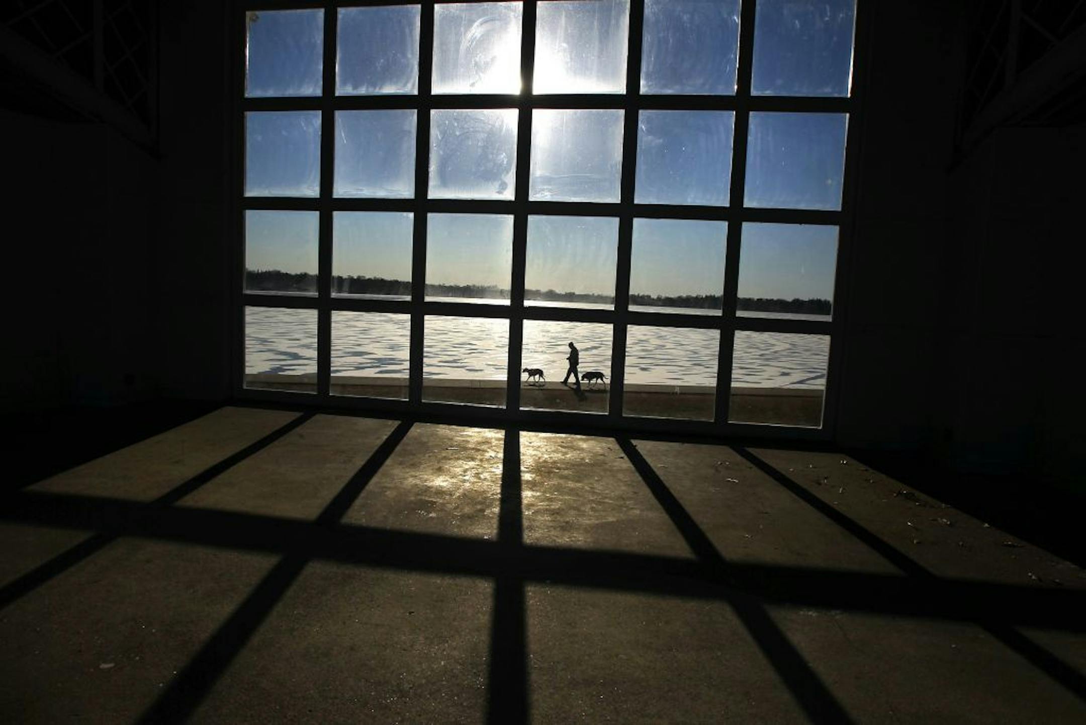 Light and shadows danced through the windows at the Lake Harriet band shell as many area residents, including those waling their pets, enjoyed the mild weather to enjoy a walk along the paths on Christmas morning.