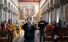 Calvin O’Connor plays trumpet as students listen and make note of the sounds in the seminary chapel during an interdisciplinary music and physics cl