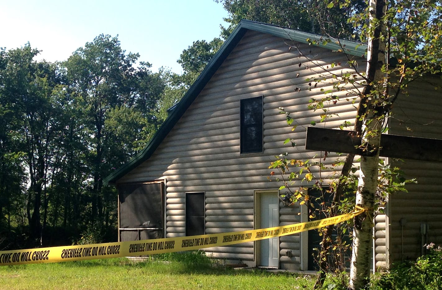 Police tape blocks the entrance to the cabin near the spot where the body of Alayna Ertl, 5, of Watkins, was found Saturday. The cabin, which is northwest of Brainerd, belongs to the family of Zachary T. Anderson, who is being held in connection with the girl's death. ] Emma Nelson, Star Tribune