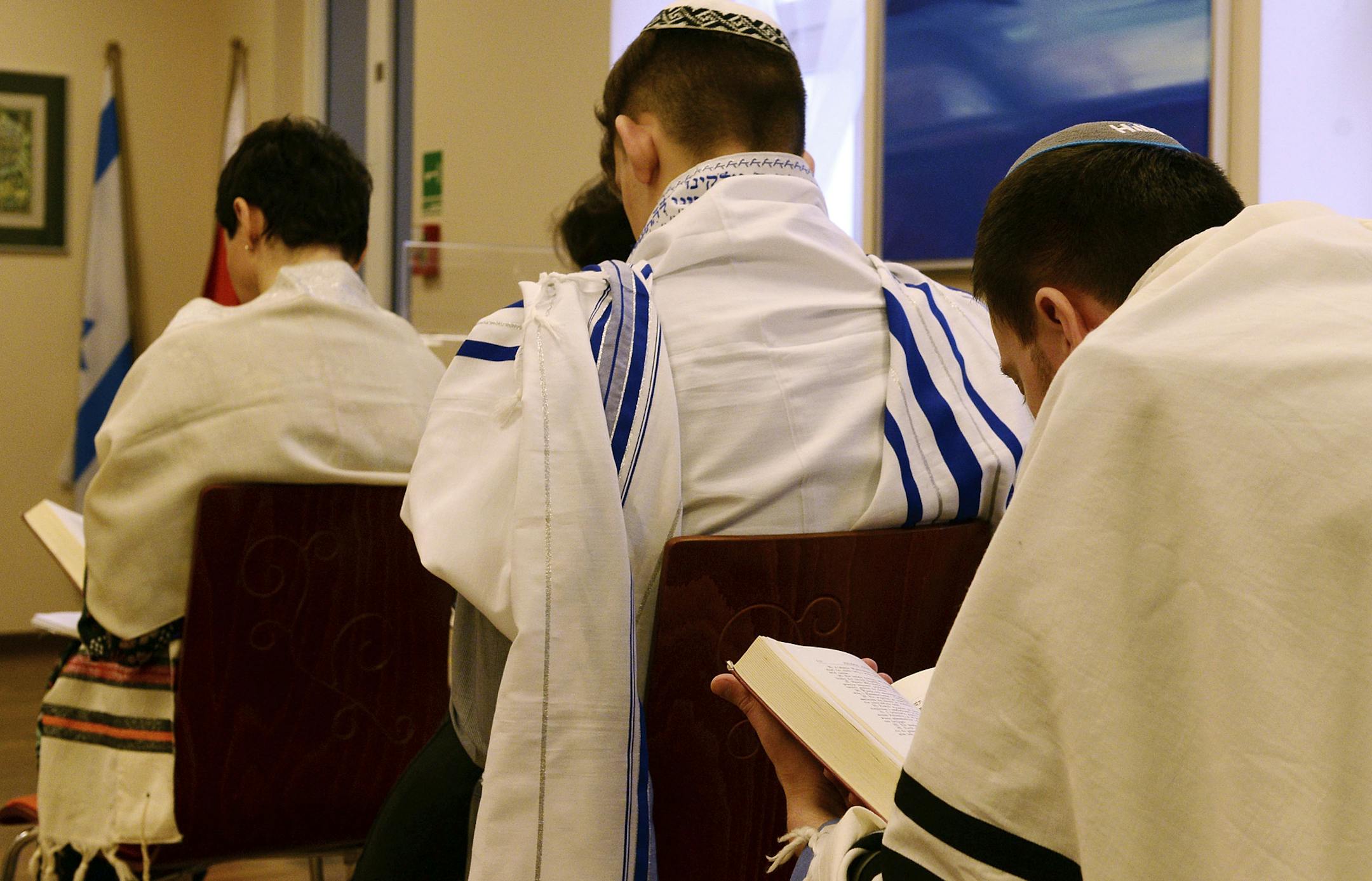 Jewish people pray in a synagogue in Warsaw, Poland, Saturday, Feb. 10, 2018. Many members of Poland's small Jewish community have been left feeling stunned and scared by an eruption of anti-Semitic rhetoric in mainstream Polish public debate. The hostile rhetoric, unheard in public life in decades, comes amid a diplomatic crisis with Israel over a new Polish law that criminalizes some forms of Holocaust speech. (AP Photo/Alik Keplicz)