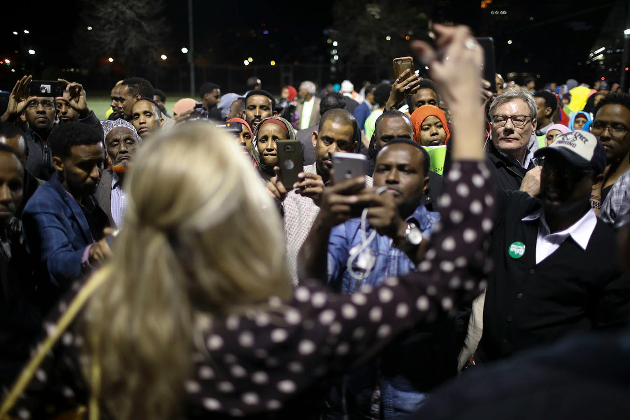 A woman who refused to identify herself, explained results to caucus goers after a vote was taken to determine delegates supporting either Abdi Warsame or Mohamud Noor to the city convention.