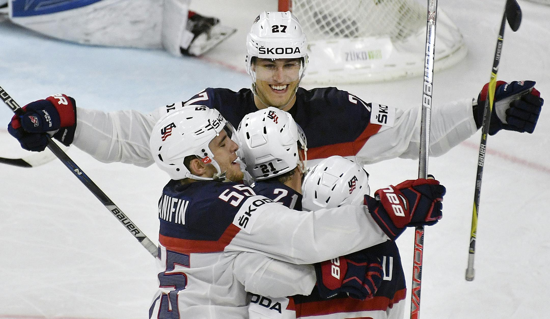 US forward Anders Lee, up, celebrates with his team after scoring his side's 4th goal during the Ice Hockey World Championships group A match between Russia and USA at the LANXESS arena in Cologne, Germany, Tuesday, May 16, 2017. Russia was defeated by the USA with 3-5. (AP Photo/Martin Meissner)
