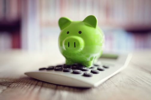 Piggy bank on calculator concept for saving, accounting, banking and business account. istock