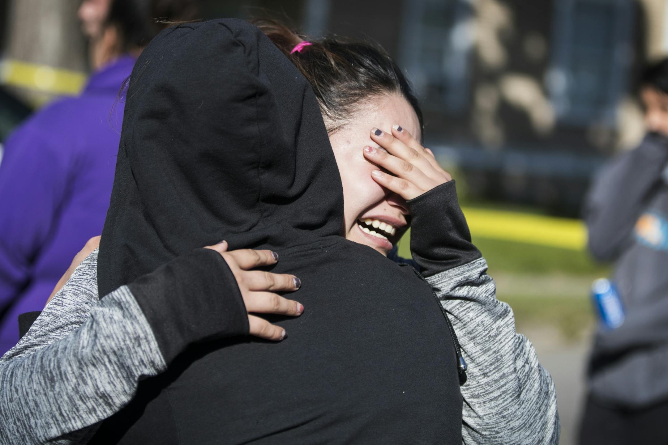 Family of the adult male victim grieve at the scene of the shooting.