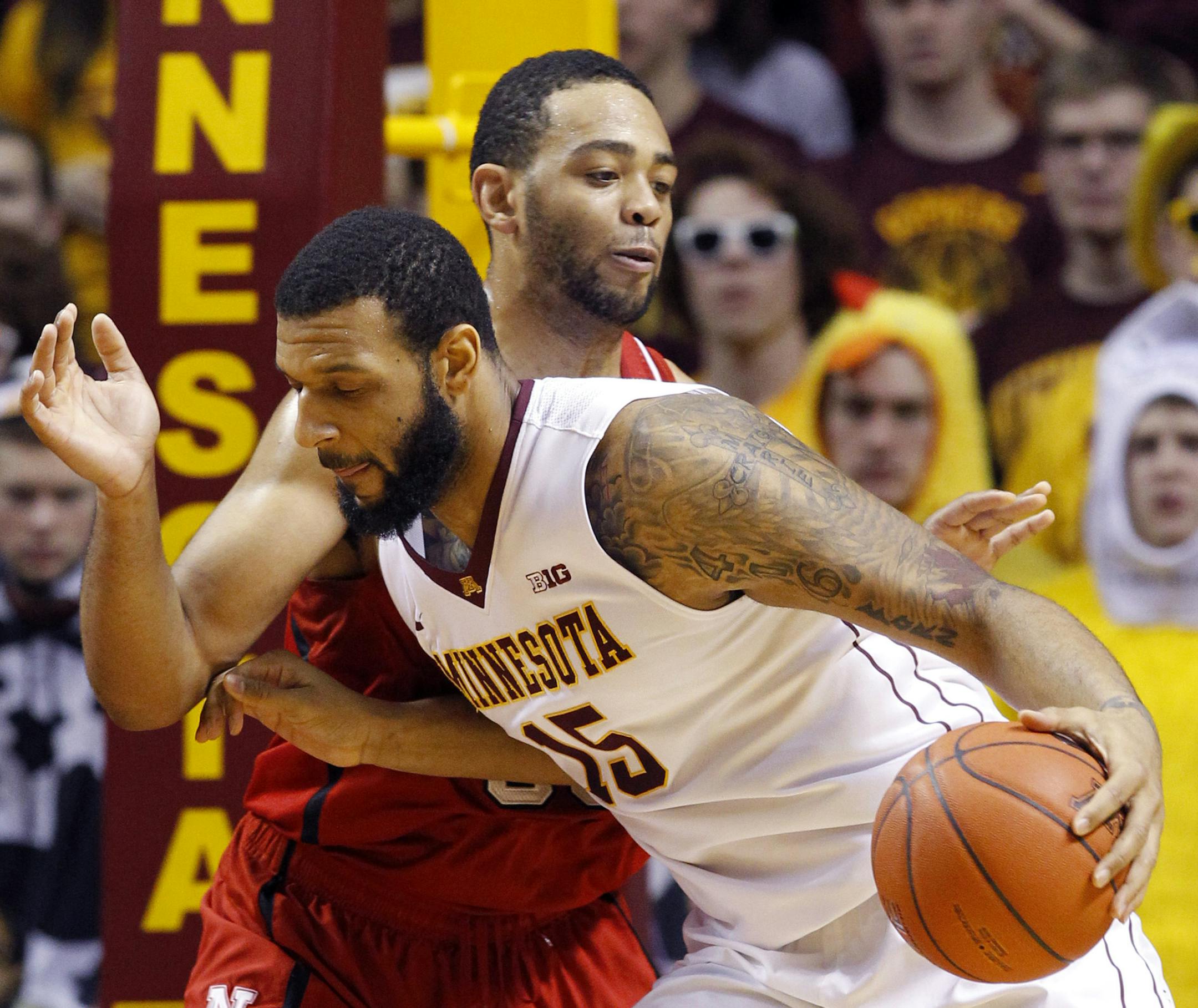 Minnesota forward Maurice Walker (15) drives against Nebraska forward Walter Pitchford, rear, during the first half of an NCAA college basketball game in Minneapolis, Saturday, Jan. 31, 2015. (AP Photo/Ann Heisenfelt)