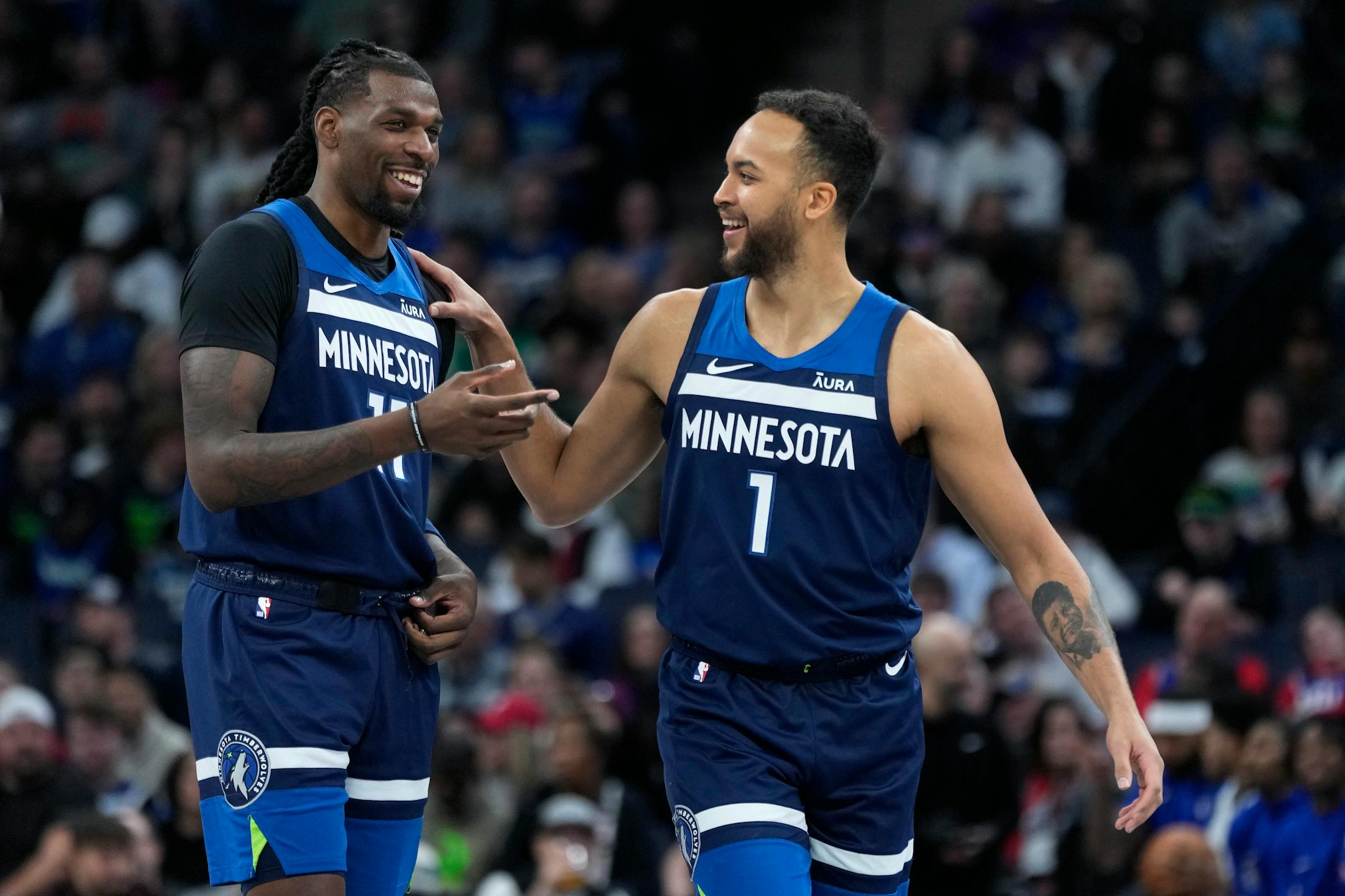 Minnesota Timberwolves center Naz Reid (11) and forward Kyle Anderson (1) smile during the first half of the team's NBA basketball game against the Philadelphia 76ers, Wednesday, Nov. 22, 2023, in Minneapolis. (AP Photo/Abbie Parr) ORG XMIT: MER77e7f27d8415a8de76ba79d4c8fde