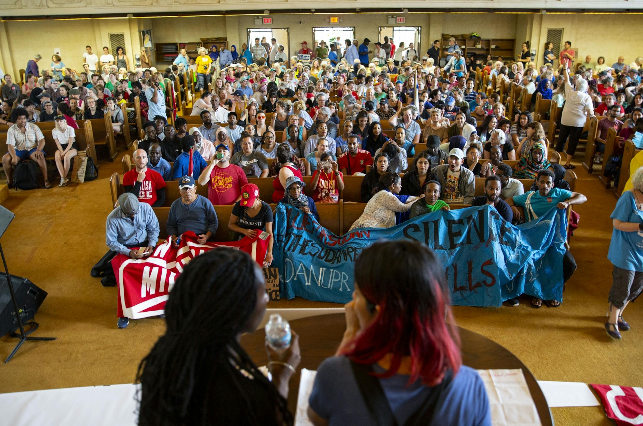 Organizers prepare to speak in front of the crowd of protestors who gathered in the First Universalistic Church of Minneapolis after the march. ALEX KORMANN ¥ alex.kormann@startribune.com Approximately 1,000 people marched through the streets of Minneapolis on Sunday June 30, 2019 protesting the treatment of migrants on the U.S. border. "Stop separating families, close the camps," said Mari Mansfield, an organizer for the event.