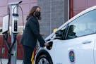Vice President Kamala Harris charges an electric vehicle in one of the charging stations on Dec. 13 during her tour of the Brandywine Maintenance Faci
