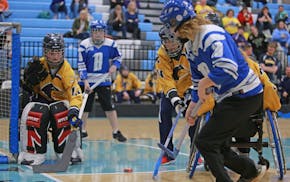 Brainerd's Cody Vleck makes a shot on goal as Madelyn Ausk from Robbinsdale/Hopkins/MoundWest prepares to block it during the physically impaired stat
