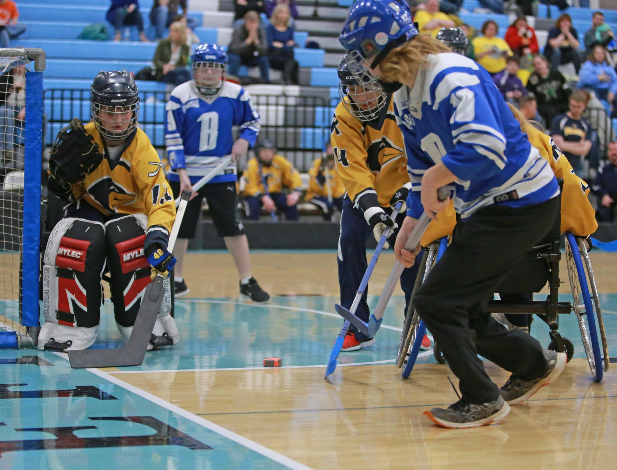Brainerd's Cody Vleck makes a shot on goal as Madelyn Ausk from Robbinsdale/Hopkins/MoundWest prepares to block it during the physically impaired state tournament game on Saturday, March 17, 2018 at Thomas Jefferson High School in Bloomington, Minn. [Ellen Schmidt ï ellen.schmidt@startribune.com
