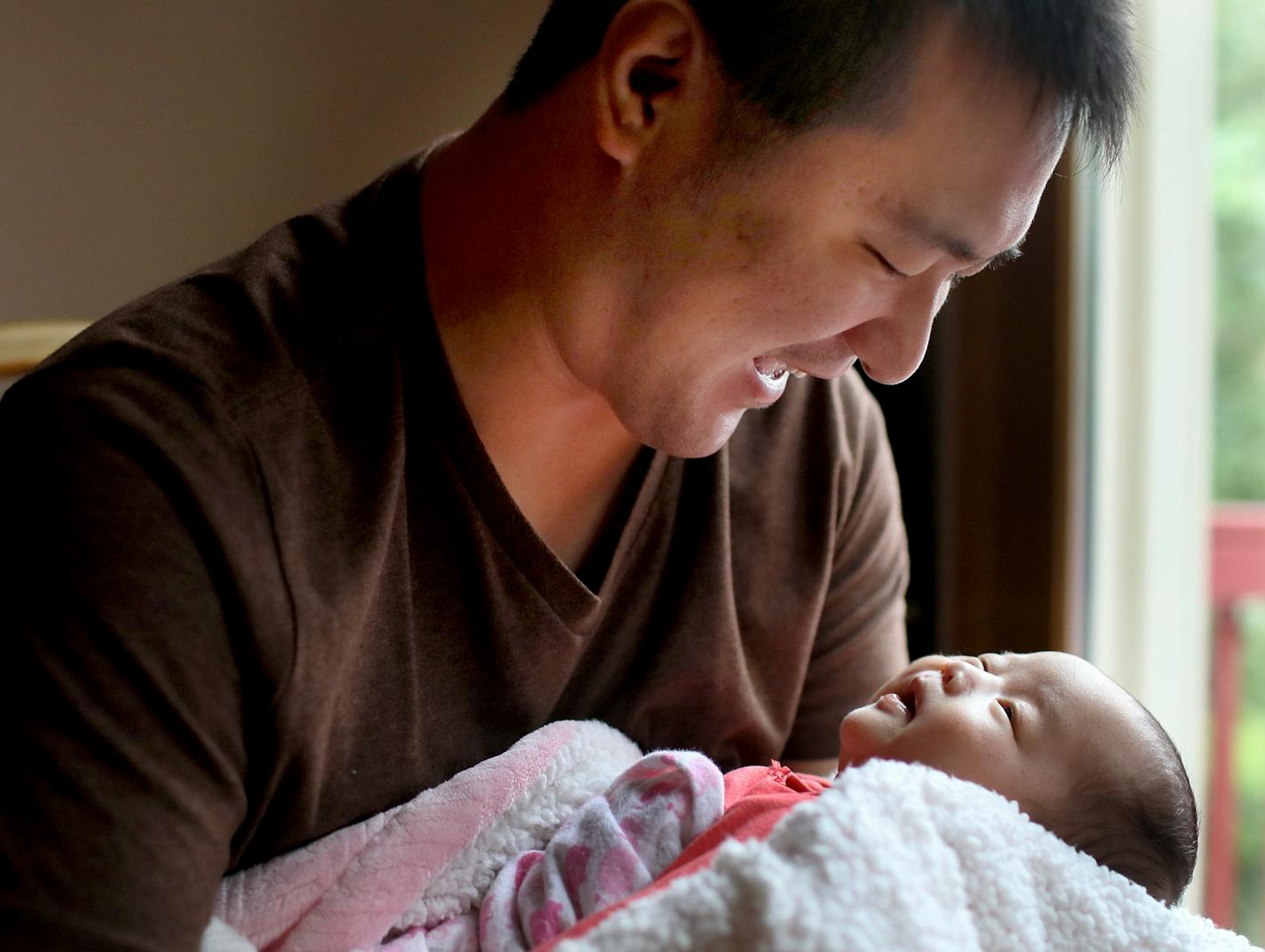 Le Wang, 31, a business analyst, is concerned that a new immigration rule would make it impossible for his relatives to emigrate from China to the U.S., where they could spend time with his newborn daughter in Cottage Grove.