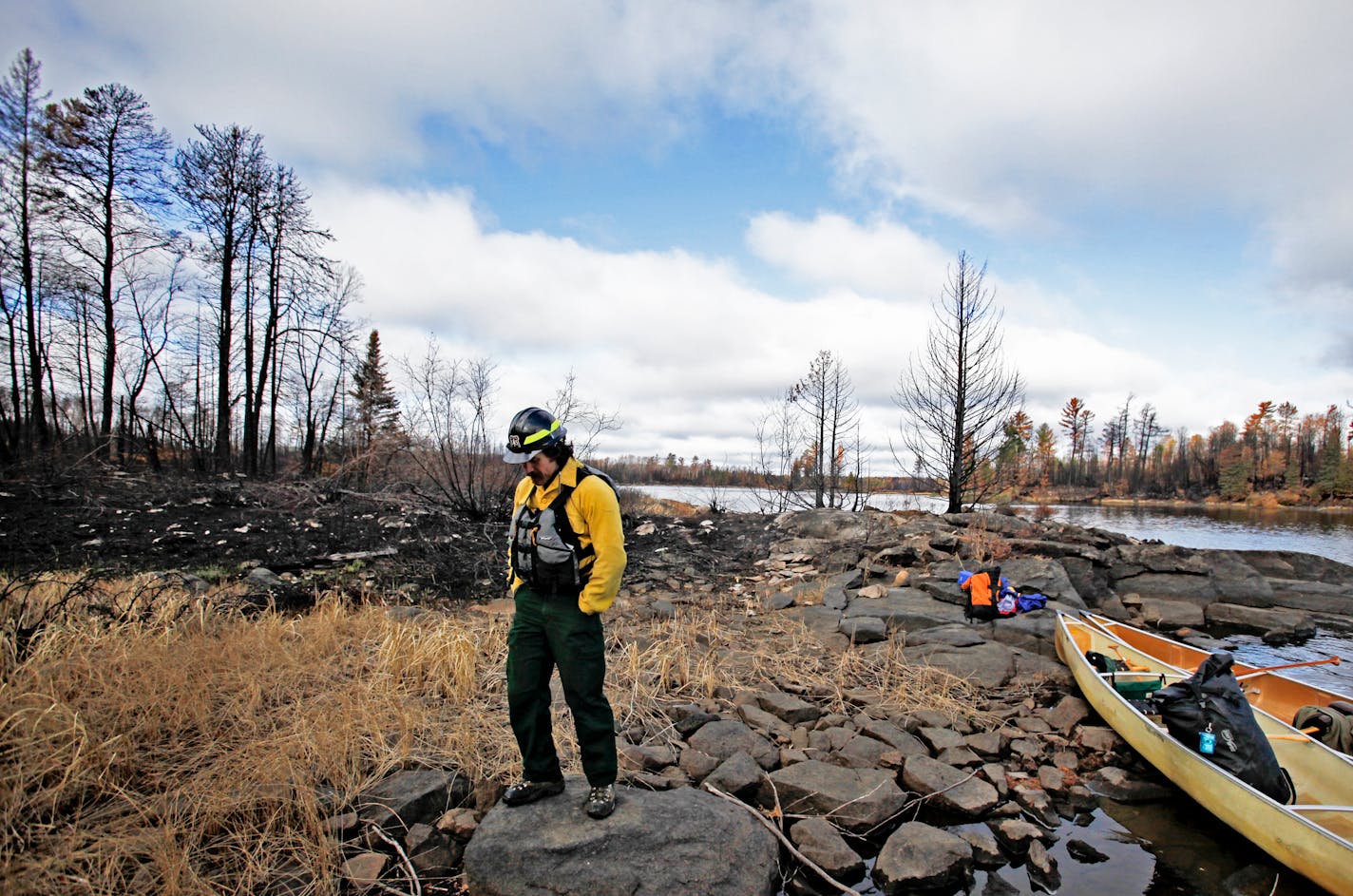 Carl Skustad, zone wilderness manager for the U.S. Forest Service, paused on a rock while surveying damage to the campsite 7 area on Lake Three in the BWCA, near Ely, MN. Wednesday, Oct. 19, 2011.] - Ely, MN DAVID JOLES*djoles@startribune.com