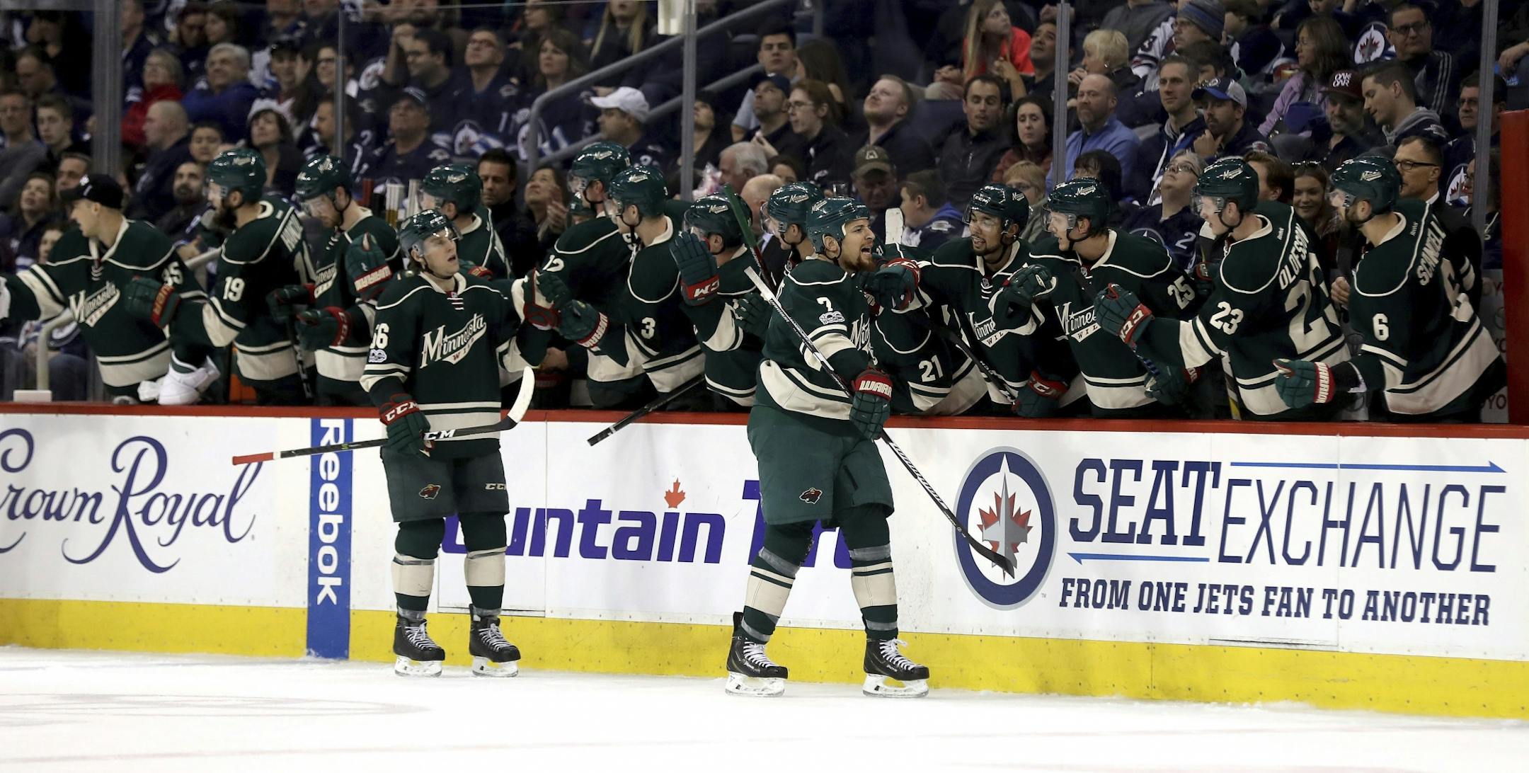 Minnesota Wild's Chris Stewart (7) celebrates with the bench after he scored against the Winnipeg Jets during second-period NHL hockey game action in Winnipeg, Manitoba, Sunday, March 19, 2017.