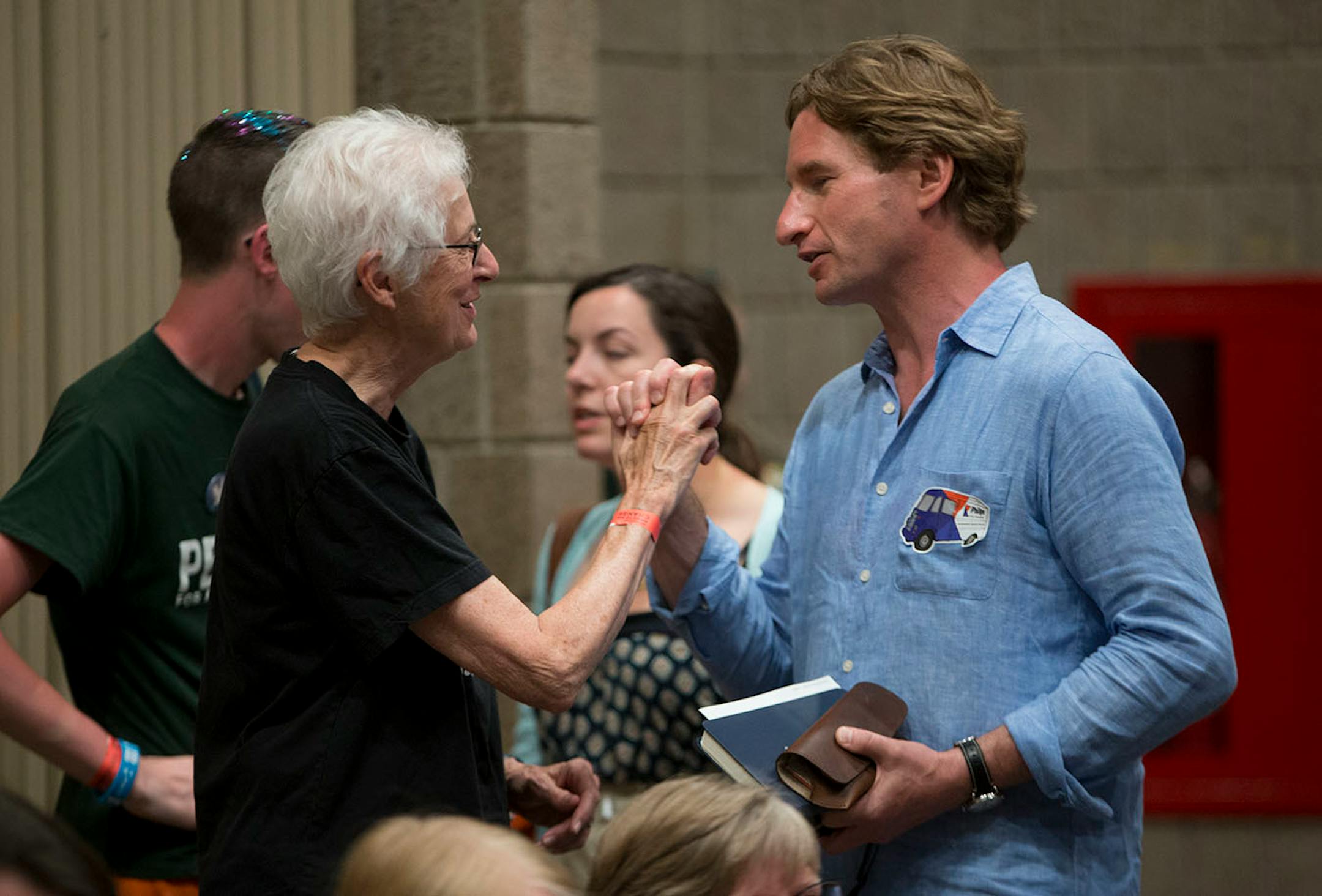 Phyllis Kerr joins hands with Dean Phillips, a Democrat running against Erik Paulson for Congressman of Minnesota.