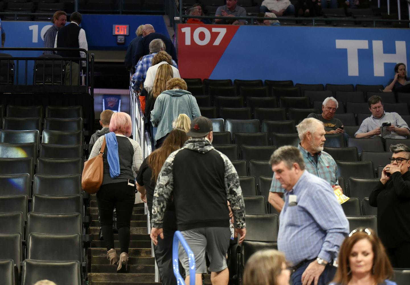 Basketball fans leave Chesapeake Energy Arena after it is announced that an NBA basketball game between Oklahoma City Thunder and Utah Jazz in Oklahoma City has been postponed, Wednesday, March 11, 2020. (AP Photo/Kyle Phillips)