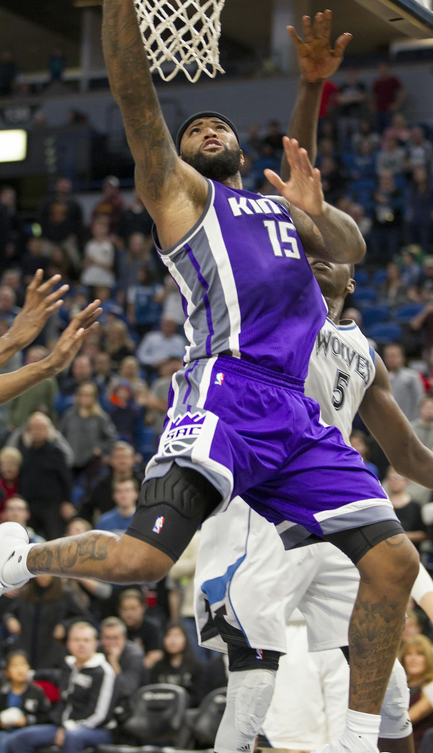 Sacramento Kings forward DeMarcus Cousins (15) shoots against Minnesota Timberwolves forward Gorgui Dieng (5) during the second half of an NBA basketball game, Friday, Dec. 23, 2016, in Minneapolis. The Kings won 109-105. (AP Photo/Paul Battaglia)