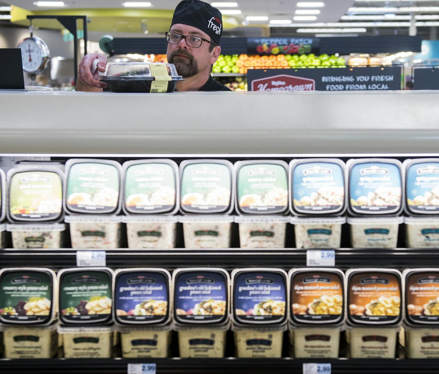 Jamie Fugle sorts meals in the expanded grab-and-go food section. ] Isaac Hale &#xef; isaac.hale@startribune.com A new Hy-Vee supermarket is set to open at 16150 Pilot Knob Rd. in Lakeville, MN, tomorrow. The supermarket offers several new features and improvements such as a clothing department, Mexican Cucina Grill, sweets shop, and expanded grab-and-go meal options.