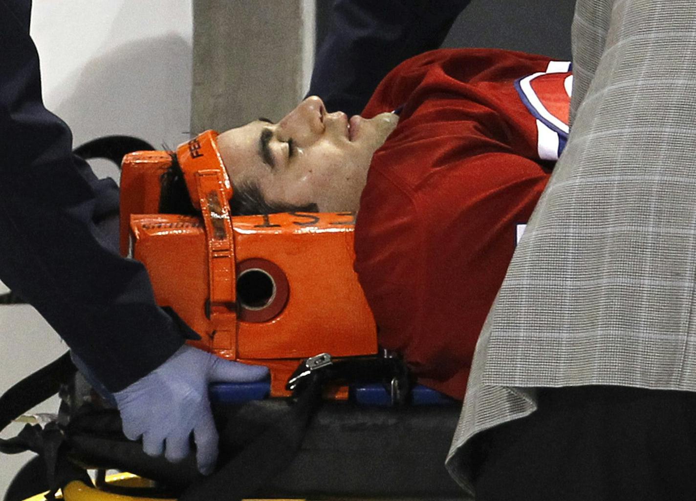 In this photo taken, Tuesday, March 8, 2011, Montreal Canadiens' Max Pacioretty is wheeled away on a stretcher after taking a hit from Boston Bruins' Zdeno Chara during second period NHL hockey action in Montreal. Pacioretty has been diagnosed with a severe concussion and a fractured vertebra. (AP Photo/The Canadian Press, Paul Chiasson) ORG XMIT: MIN2016010817425740