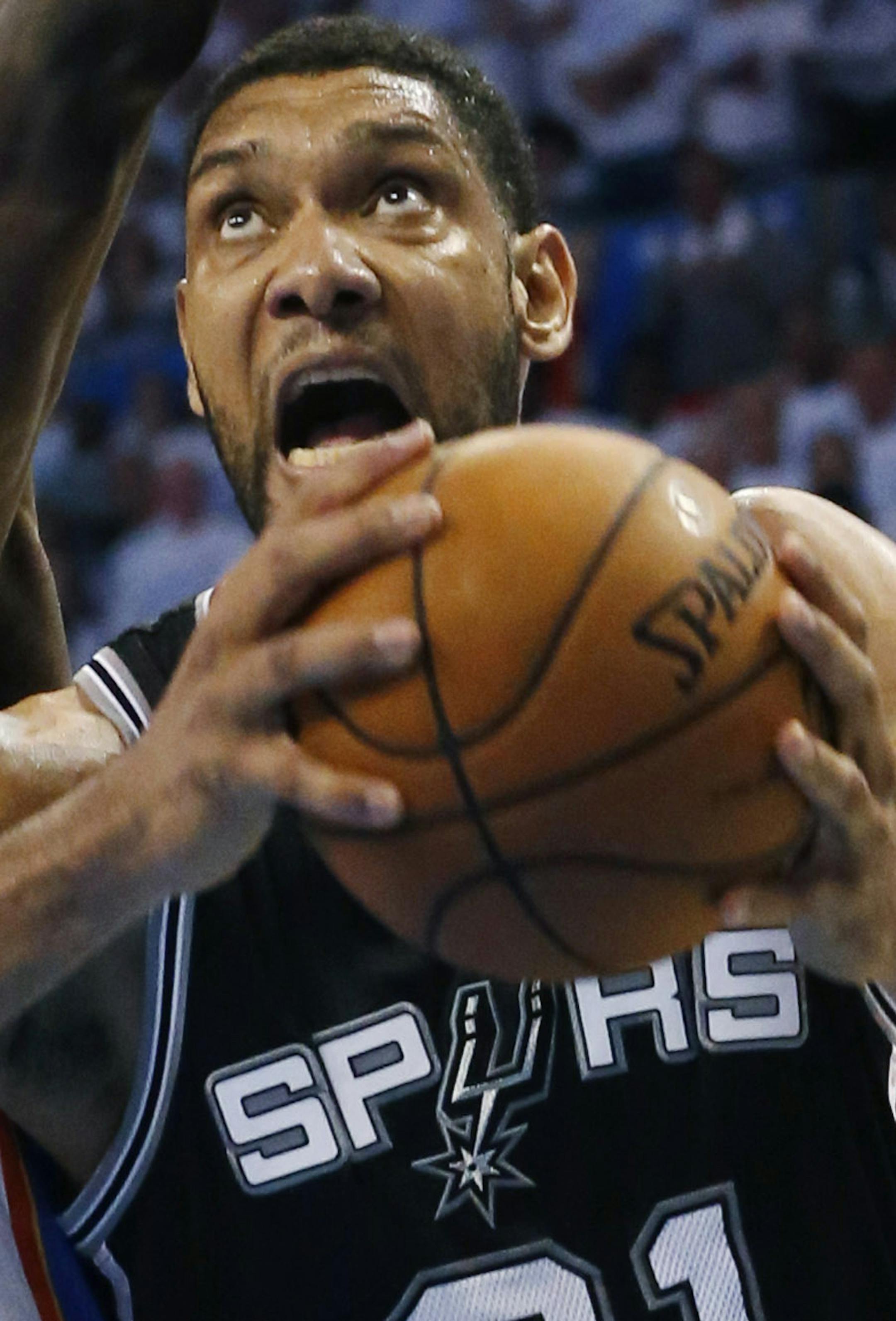 San Antonio Spurs forward Tim Duncan (21) shoots against Oklahoma City Thunder forward Serge Ibaka in overtime of Game 6 of the Western Conference finals NBA basketball playoff series in Oklahoma City, Saturday, May 31, 2014. San Antonio won 112-107 and advanced to the NBA Finals. (AP Photo/Sue Ogrocki) ORG XMIT: TXKJ162
