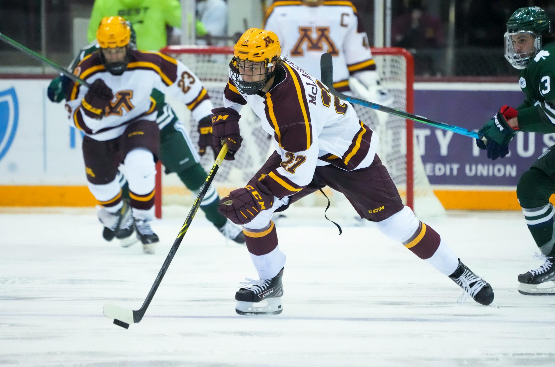 Minnesota forward Blake McLaughlin (27) skated with the puck in the second period.