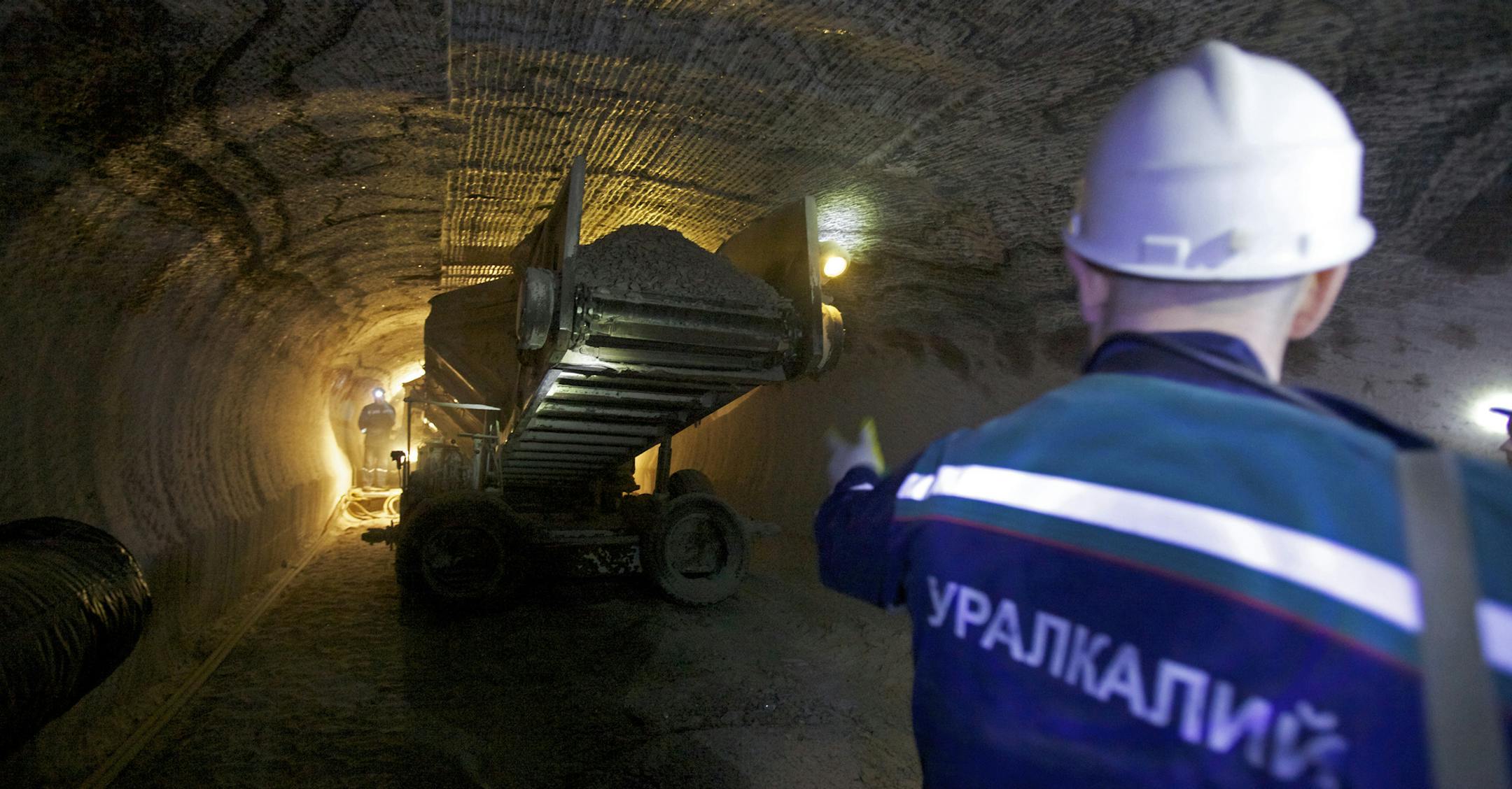 An employee watches a machine transporting potash ore in the OAO Uralkali potash mine in Berezniki, Russia, on Thursday, March 17, 2011. Uralkali plans to merge with domestic rival OAO Silvinit to overtake Potash Corp. of Saskatchewan Inc. as the largest producer. Photographer: Alexander Zemlianichenko Jr/Bloomberg ORG XMIT: 110400510
