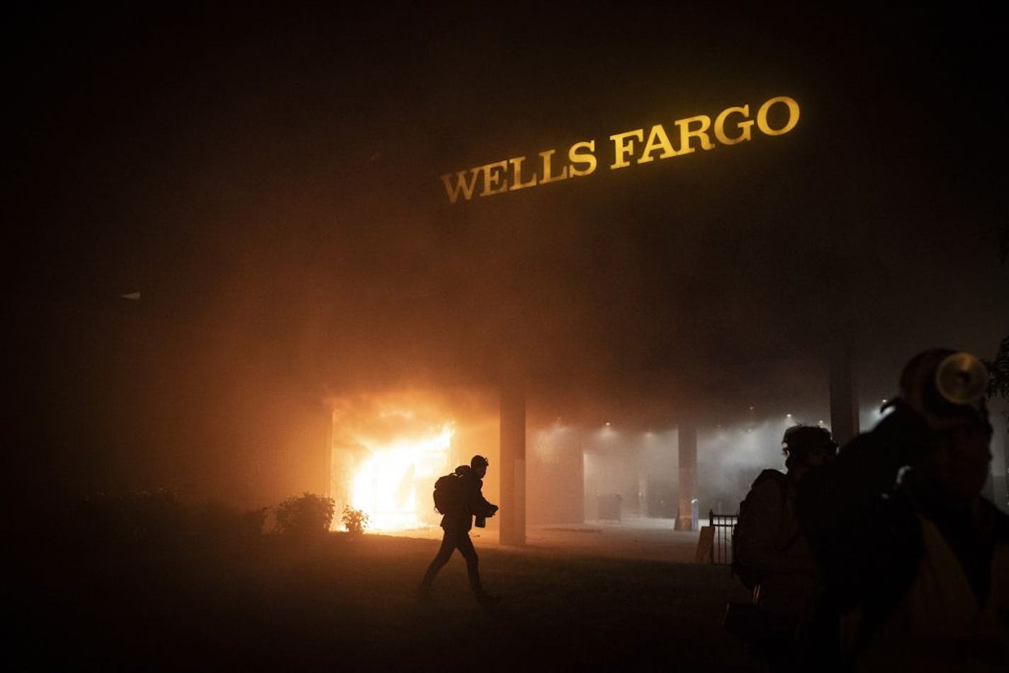 Smoke billows from a fire at the Wells Fargo near the Fifth Precinct in Minneapolis on Friday, May 29, 2020.