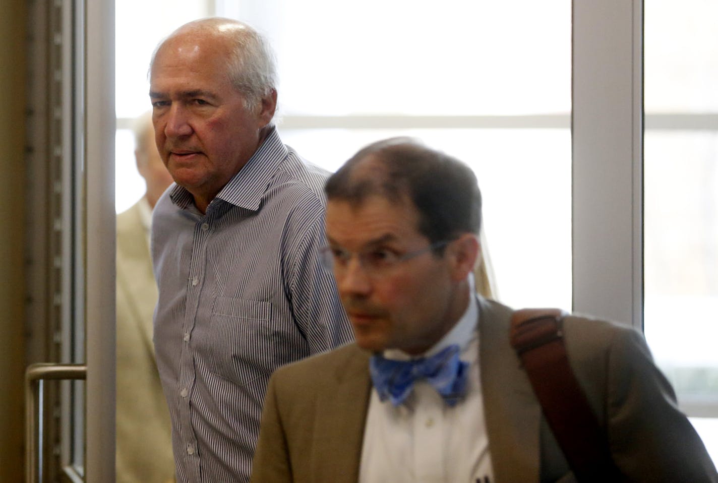 Philip Nelson's father, Pat Nelson, enters the Blue Earth County courthouse for Philip's court appearance. In the foreground is Nelson's attorney, Jim Fleming, who served as MSU-Mankato football coach Todd Hoffner's attorney during his legal issues.