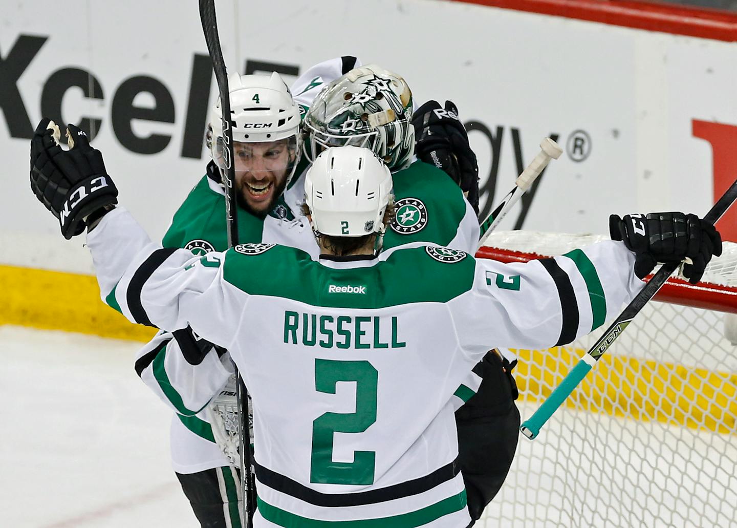 Dallas Stars' Jason Demers, left, and Kris Russell celebrate with goalie Antti Niemi, of Finland, after the Stars beat the Minnesota Wild 3-2 in Game 4 in the first round of the NHL Stanley Cup hockey playoffs Wednesday, April 20, 2016, in St. Paul, Minn. (AP Photo/Jim Mone)