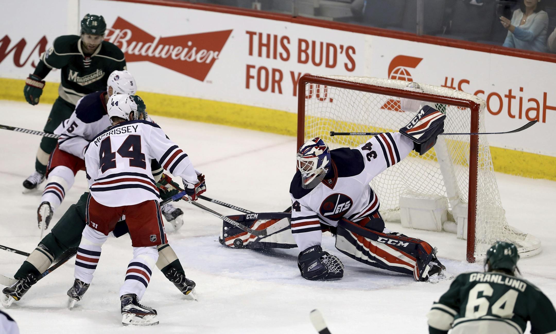 Winnipeg Jets goaltender Michael Hutchinson (34) stretches out to make a save against the Minnesota Wild during third-period NHL hockey game action in Winnipeg, Manitoba, Sunday, March 19, 2017.