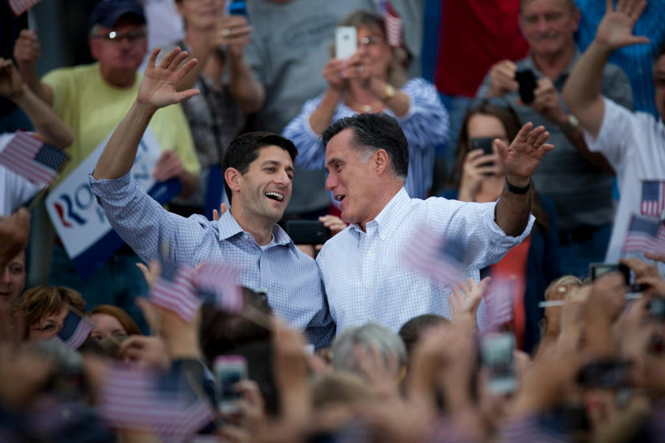 Republican vice presidential candidate Paul Ryan of Wisconsin, left, and Republican presidential candidate Mitt Romney wave to the crowd at the Waukesha County Expo Center on Sunday.