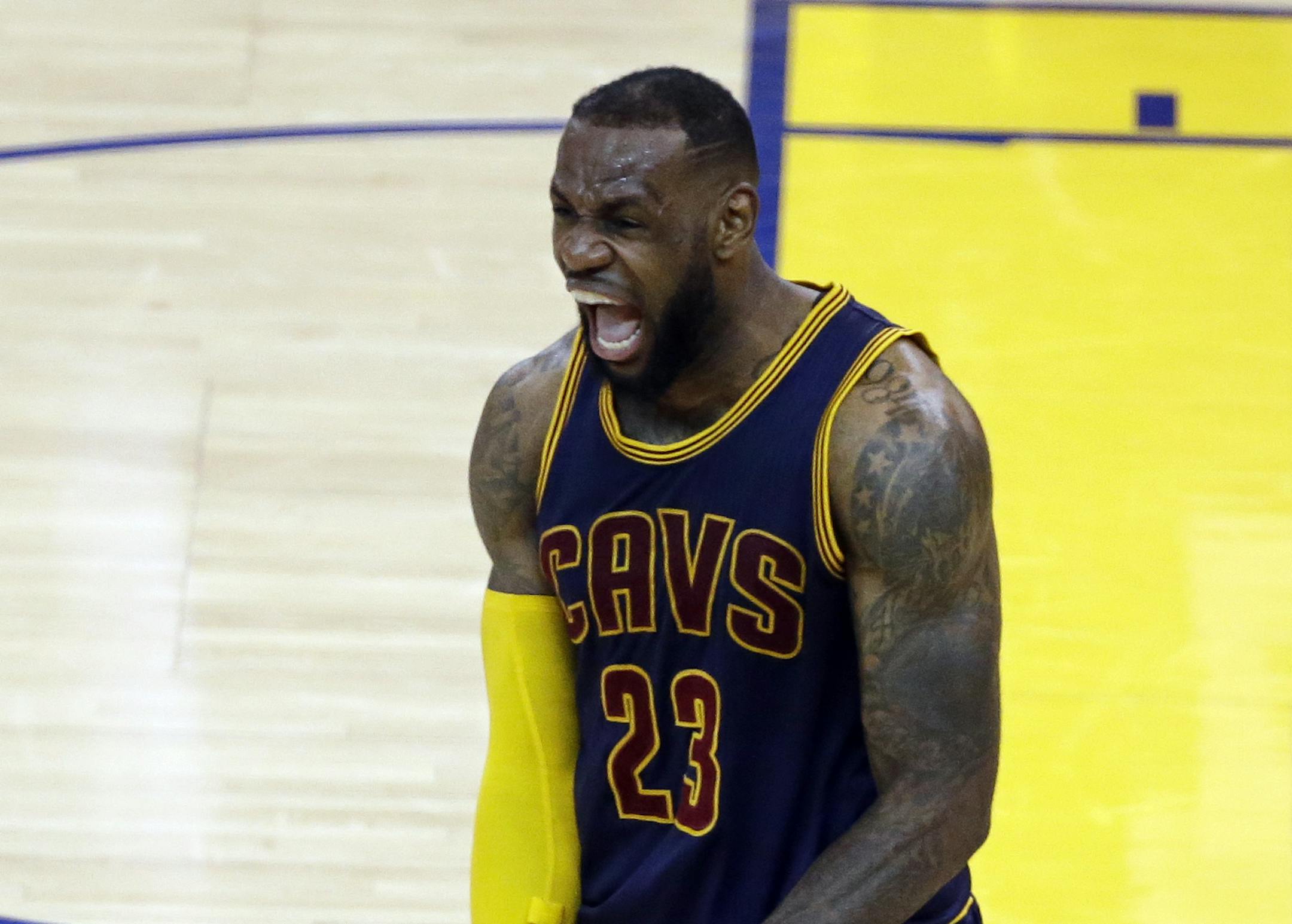 Cleveland Cavaliers forward LeBron James (23) celebrates after end of the overtime period of Game 2 of basketball's NBA Finals against the Golden State Warriors in Oakland, Calif., Sunday, June 7, 2015. The Cavaliers won 95-93 in overtime. (AP Photo/Eric Risberg)