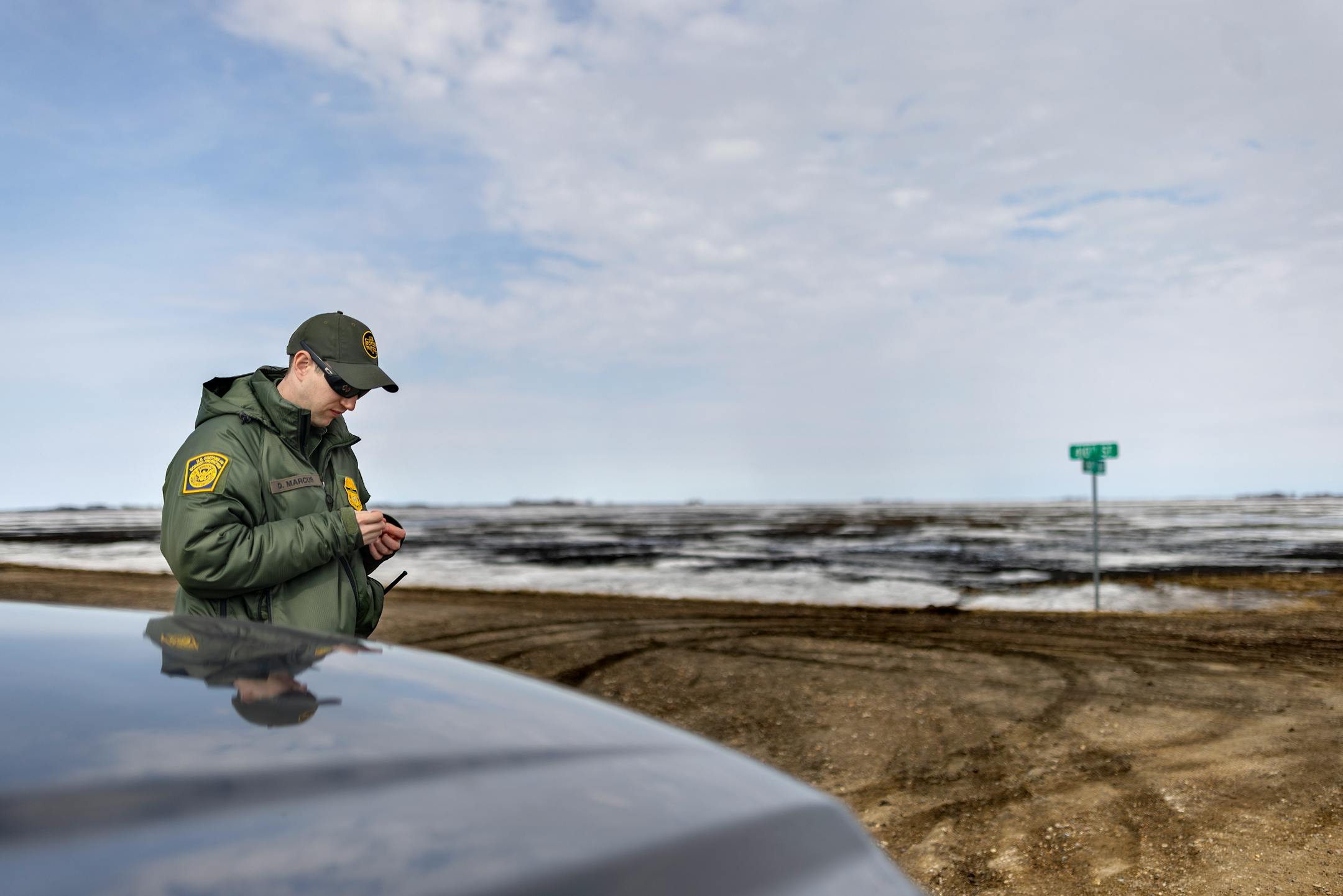 Customs and Border Patrol agent David Marcus looks for footprints near the site where two citizens from India and their human trafficker were found in the middle of a blizzard near Pembina, Minn., on Monday, March 21, 2022.