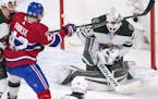 Montreal Canadiens center Byron Froese (42) is stopped by Minnesota Wild goalie Devan Dubnyk (40) during the second period of an NHL hockey game Thurs