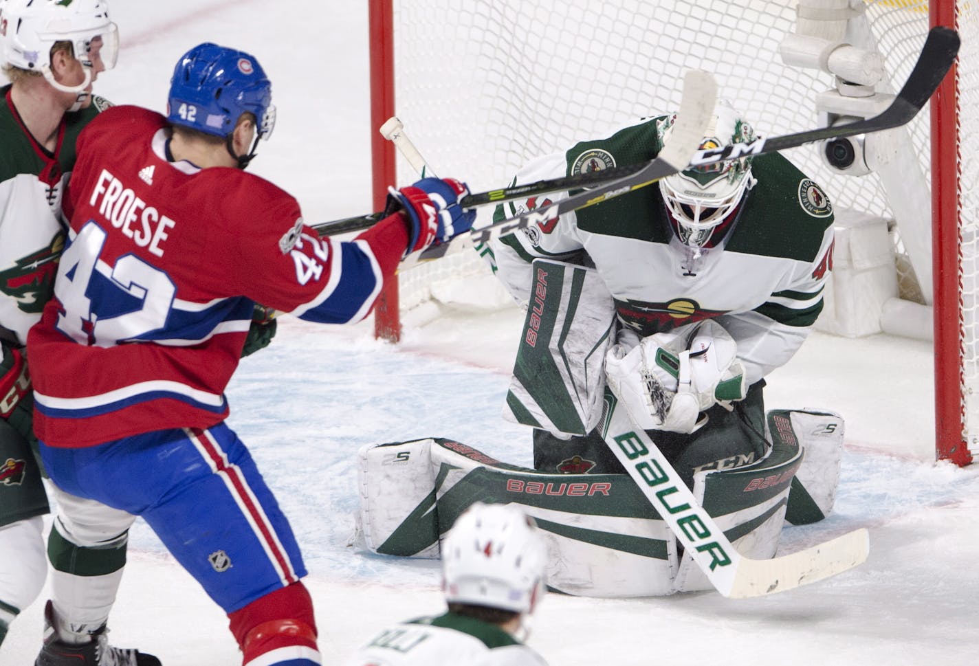 Montreal Canadiens center Byron Froese (42) is stopped by Minnesota Wild goalie Devan Dubnyk (40) during the second period of an NHL hockey game Thursday, Nov. 9, 2017, in Montreal. (Ryan Remiorz/The Canadian Press via AP)