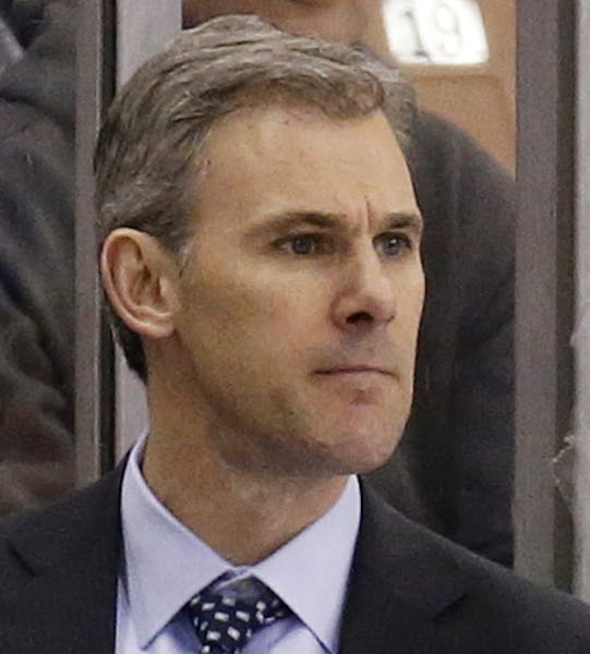 UMass Lowell head coach Norm Bazin looks on from the bench during the second period of an NCAA regional men's college hockey tournament game against C