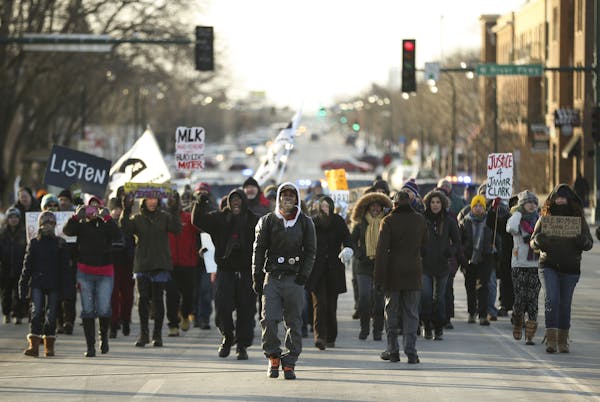 Demonstrators on the Lake Street bridge marched to meet their St. Paul counterparts Monday afternoon.