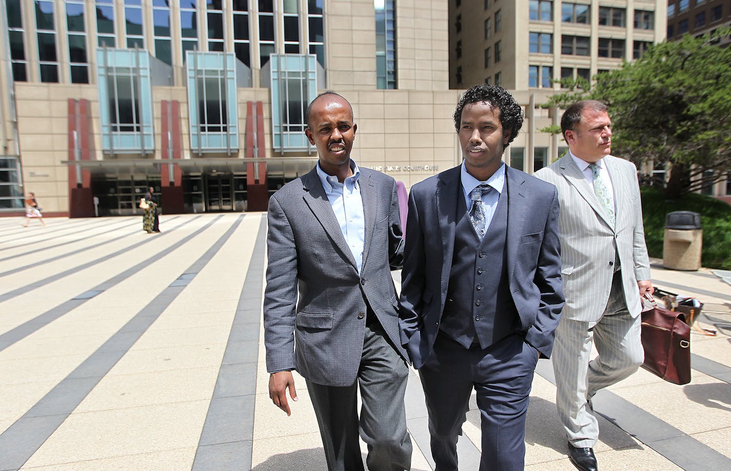 After spending seven months in federal detention, Mohamed Ali Omar, 21, walked outside the federal courthouse a free man with community advocate Sadik Warfar, left, and his attorney Paul Applebaum, right, Tuesday, June 9, 2015 in Minneapolis, MN. ] (ELIZABETH FLORES/STAR TRIBUNE) ELIZABETH FLORES &#x2022; eflores@startribune.com