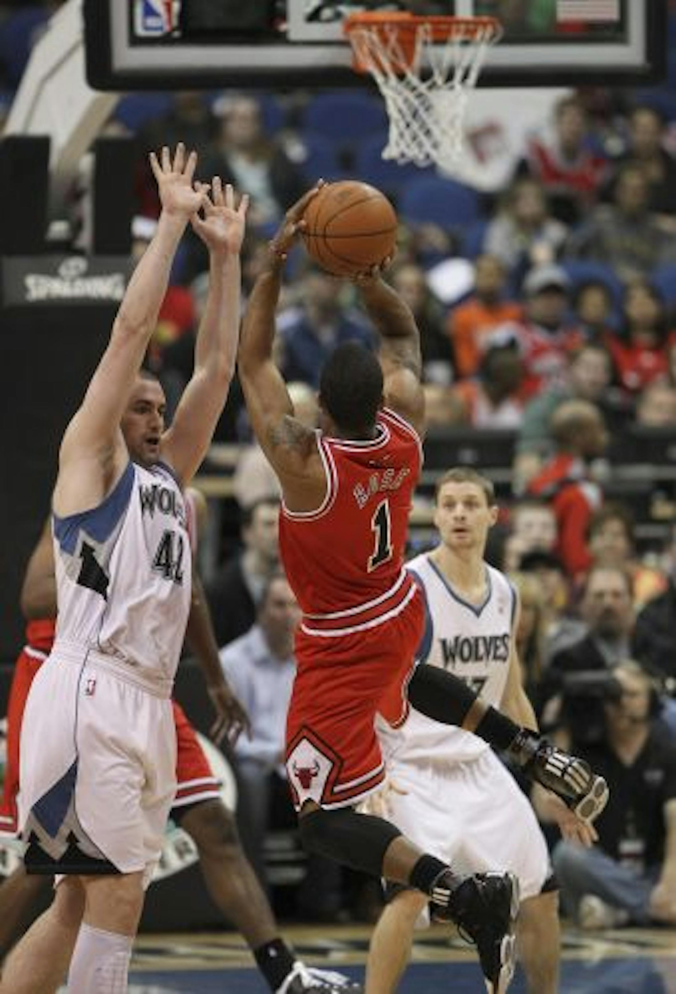Kevin Love (left) got a good view of the Bulls and star Derrick Rose (1) on Wednesday night, including this first-quarter matchup. "They're all on the same page," Love said of Chicago, whom he expected to go far in the playoffs. "You can tell everybody has utmost respect for each [other] and they're in it to win."
