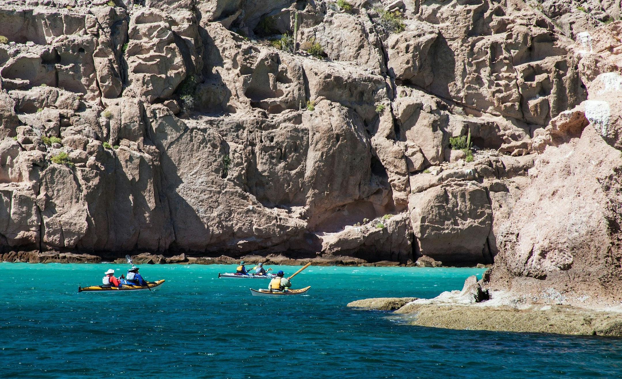 Mighty cliffs dwarf kayakers in Ensenada Grande Cove, Isla Partida, Sea of Cortez, Baja California Sur, Mexico. (Steve Haggerty/ColorWorld/MCT) ORG XMIT: 1144264