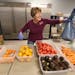Friends In Need volunteer Nancy Reckimger, happily packed up fruit and vegetables for a client at the food shelf, Tuesday, September 27, 2016 in St. P