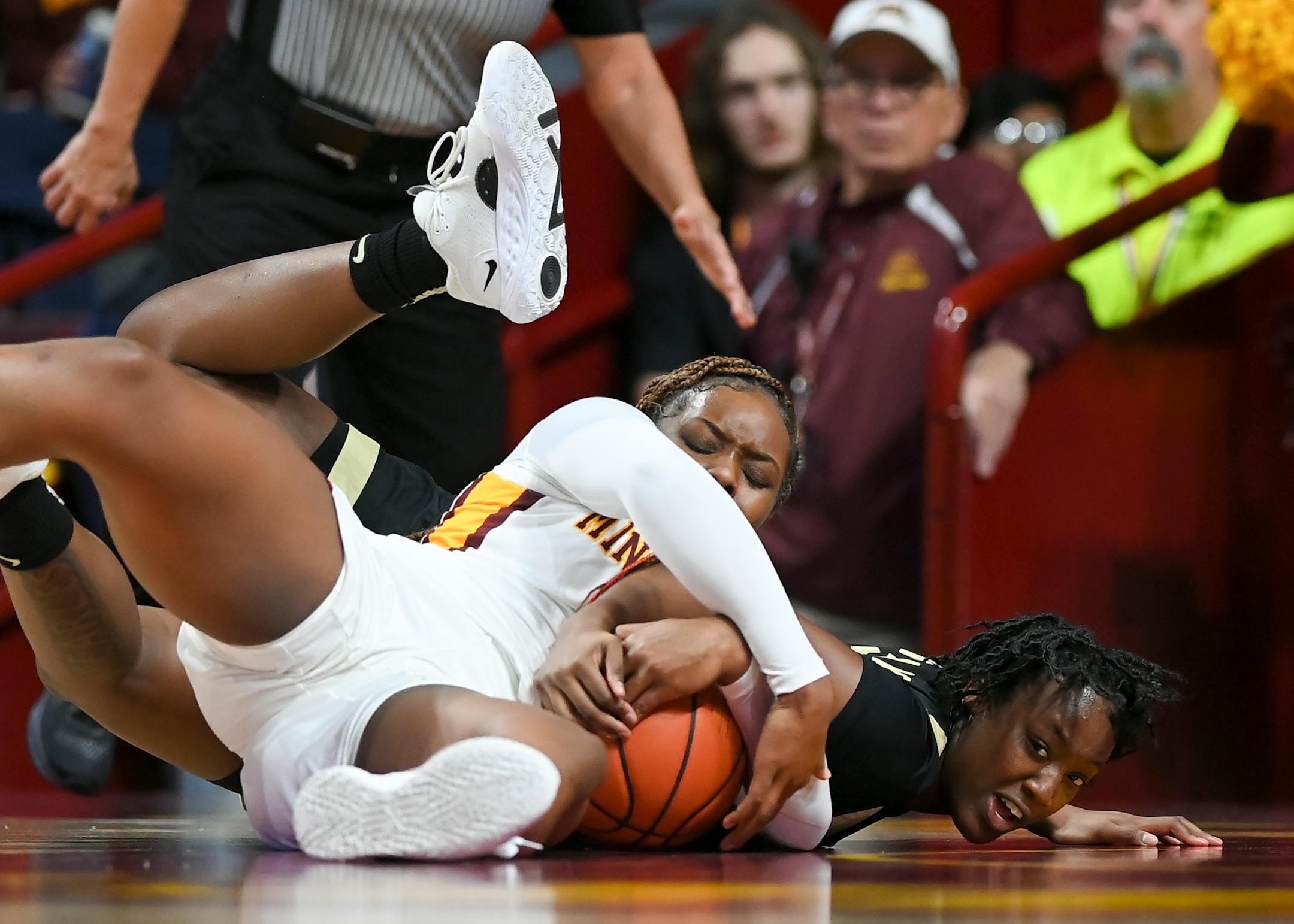 Wake Forest guard Elise Williams (21) and Minnesota Gophers forward Alanna Micheaux (4) battle for a loose ball during the second half.