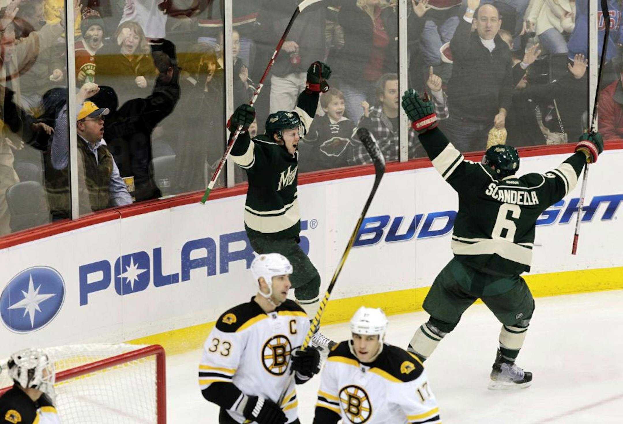 Chad Rau, left, celebrates with Marco Scandella after scoring on Boston Bruins goalie Tim Thomas