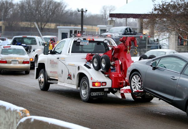 A steady stream of tow trucks bring vehciles into the city of Minneapolis auto impound lot Wednesday, Dec. 30, 2015, in Minneapolis, MN.