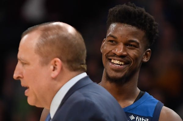 Minnesota Timberwolves guard Jimmy Butler (23) laughed behind head coach Tom Thibodeau after a dunk by forward Taj Gibson (67) in the second quarter. 