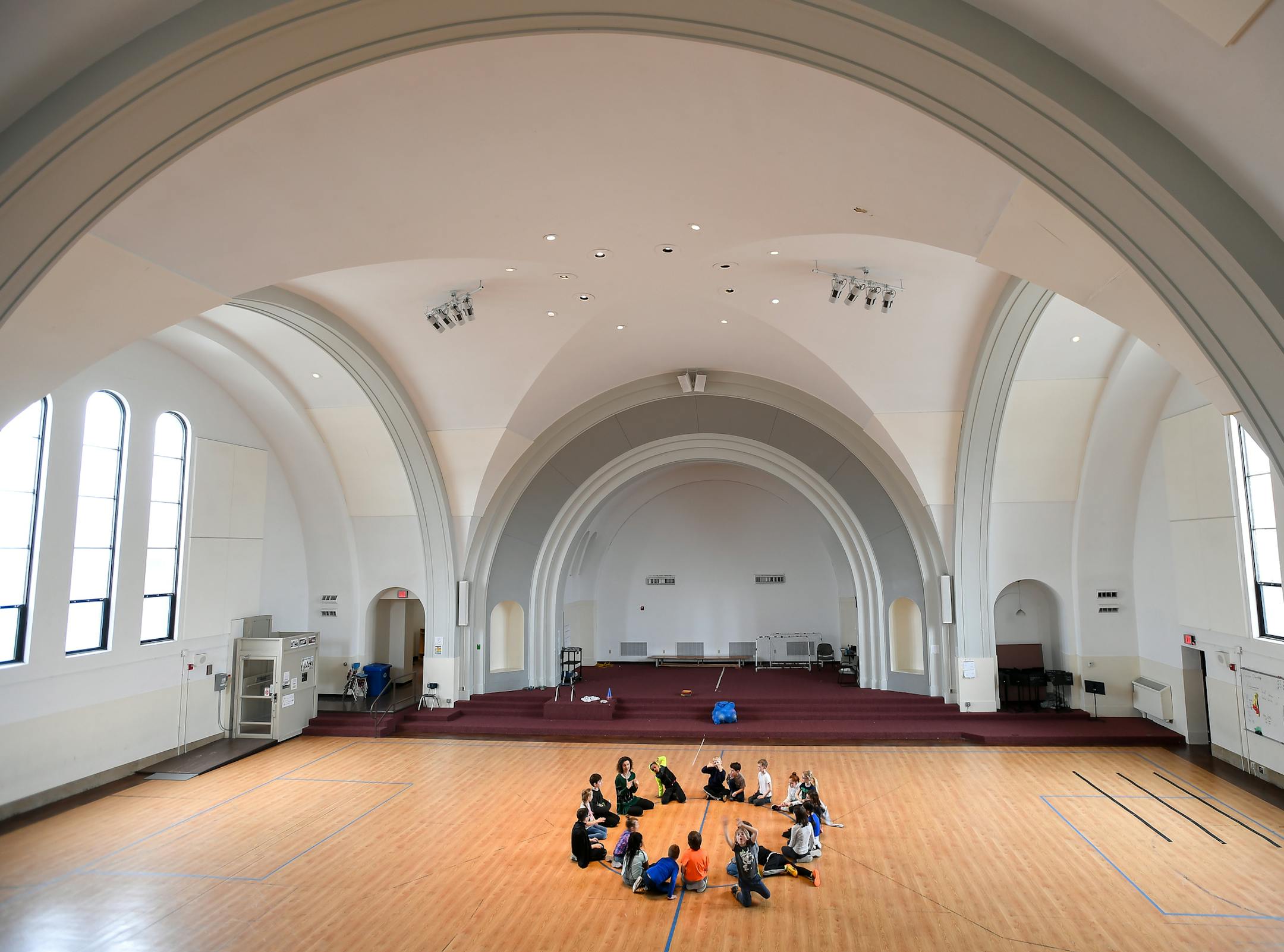 Students at the Twin Cities German Immersion School formed a circle in the former Catholic church turned gymnasium Tuesday. ] AARON LAVINSKY ï aaron.lavinsky@startribune.com Neighborhood angst is brewing in Como Park, as the Twin Cities German Immersion School considers tearing down a former Catholic church it owns and has used as a gym and cafeteria to make room for expansion. Neighbors are not happy and want the school to find a way to preserve the former St. Andrew's Catholic Church, bui